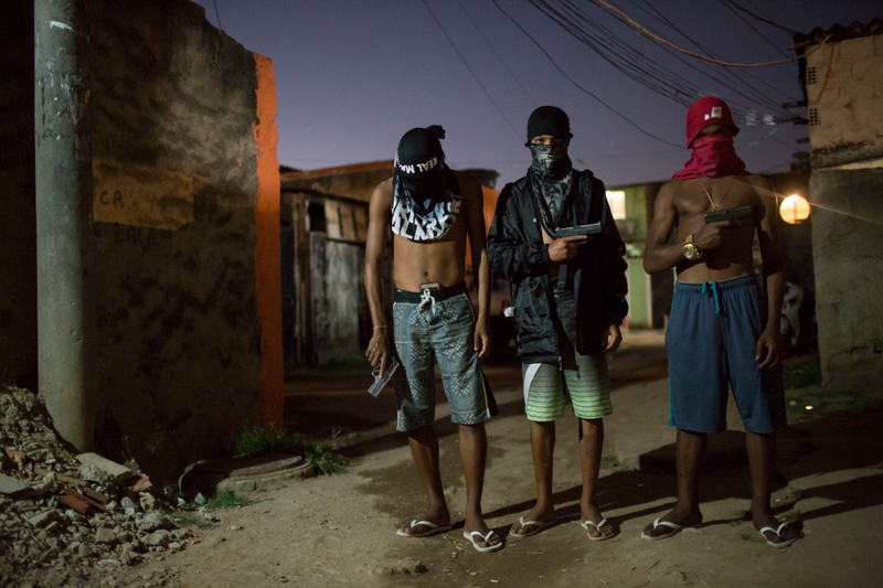 “Young drug traffickers pose for photos holding their guns at a slum in Rio de Janeiro, Brazil.”